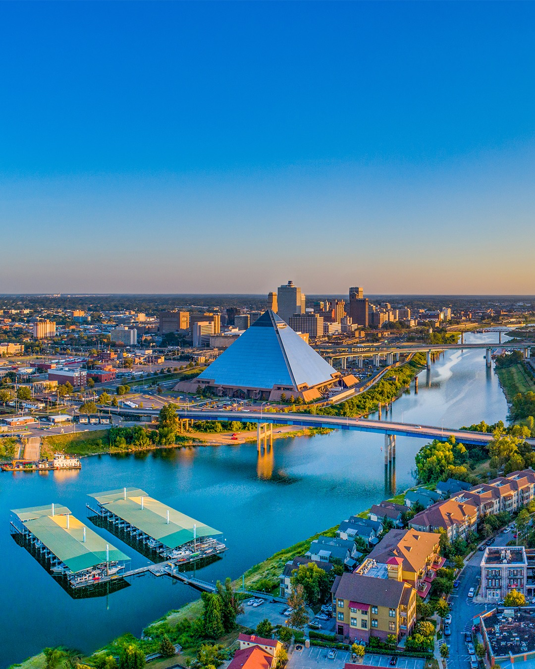 Aerial view of the Memphis skyline and Mississippi River at sunset, seen from the bluffs